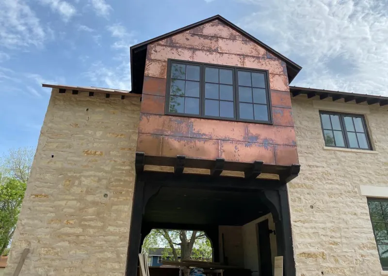 Copper metal panel facade on a stone building for Skylight Installation in Pineville